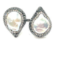 Adjustable 925 sterling silver statement ring with two teardrop gemstones and sparkling crystal accents.