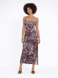 A model poses in a fitted, floral-patterned dress with a thigh-high slit and spaghetti straps.
