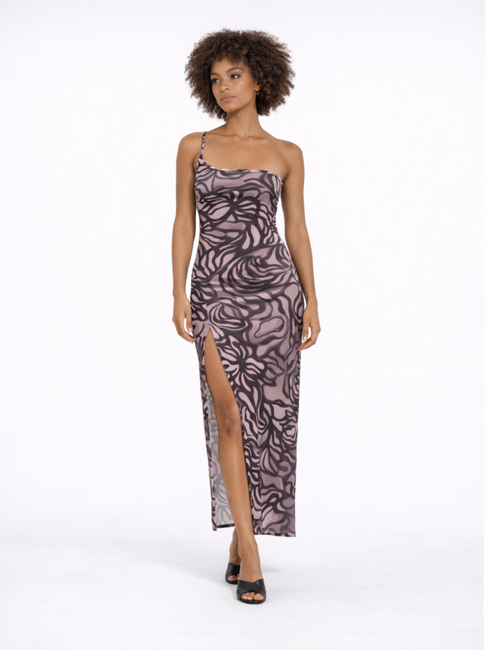 A model poses in a fitted, patterned dress with a thigh-high slit and a single shoulder strap.