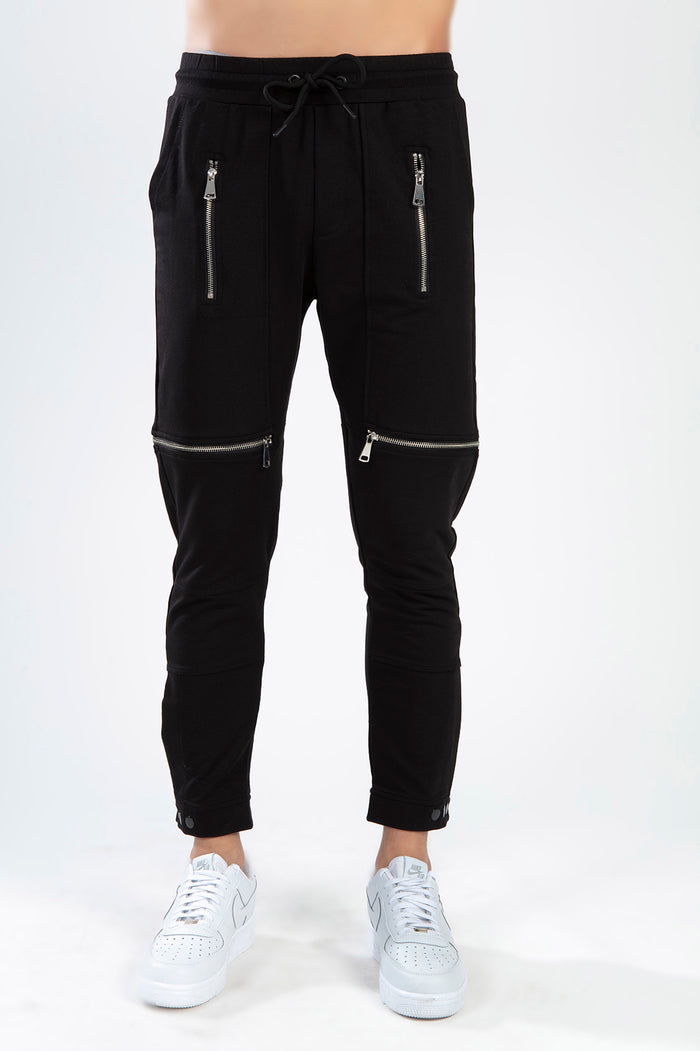 Tobias black slim-fit streetwear pants featuring silver zipper details on thighs and knees with a drawstring waist.