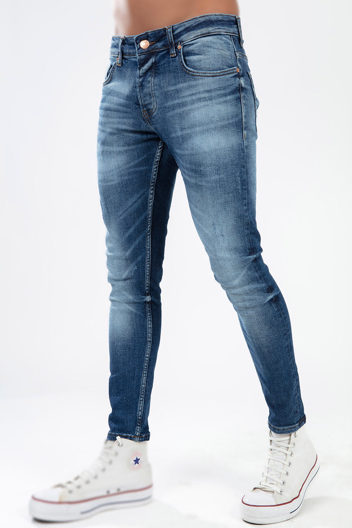 Tristan blue washed super skinny jeans for men featuring a faded denim finish and five-pocket styling on a white background.
