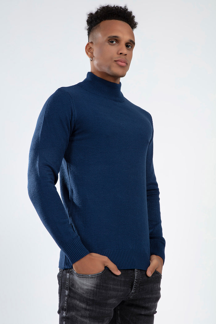 Model wearing the Tyson Knit Sweater in blue, featuring a mock neck and slim fit for a trendy streetwear aesthetic.
