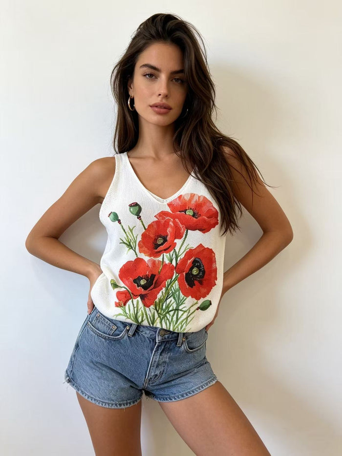 White sleeveless V-neck knit top with a vivid red poppy floral graphic on the front.