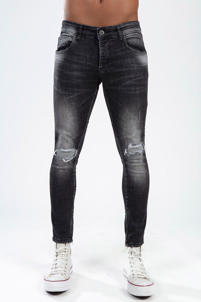 Zane men's black washed skinny jeans with distressed ripped knees and ankle zippers in a faded carbon finish.